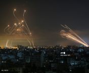 A horrificly beautiful sight over Southern Israel. The right shows Hamas rockets heading for Israel and the left shows the Isreali Iron Dome defense system missles aiming to shoot down the others. Credit goes to Anas Baba of AFP from zakiah anas pic